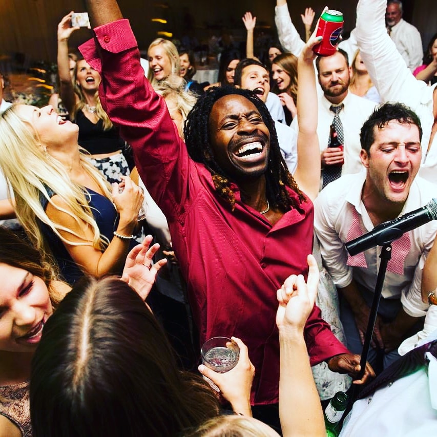 A packed, joyful dance floor at a Unique Party Band show